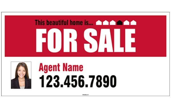 A real estate banner hangs outside a recently sold property.