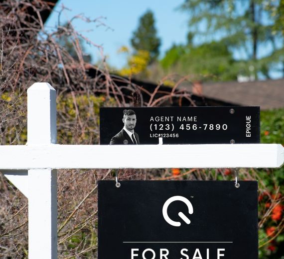 Real estate sign with agent's information visible.