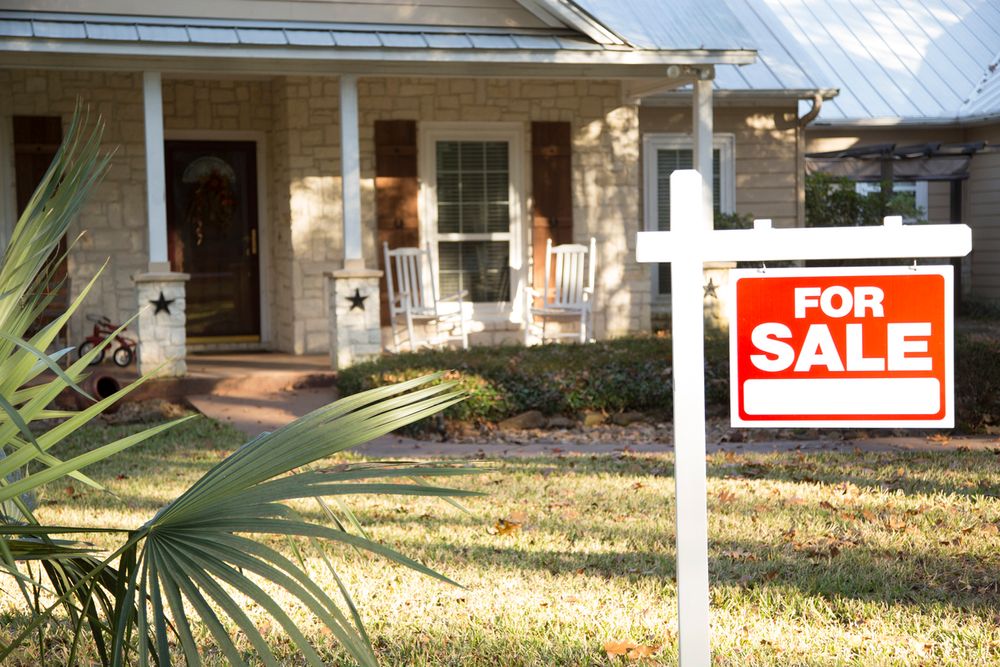 This real estate sign showcases a house that is for sale.